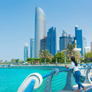 Woman overlooks Dubai skyline, highlighting the city's vibrant environment for joint ventures and business opportunities.